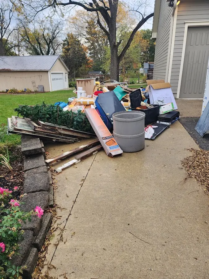 Dumpster being loaded with debris for Roofing Dumpster Rental in Oak Ridge